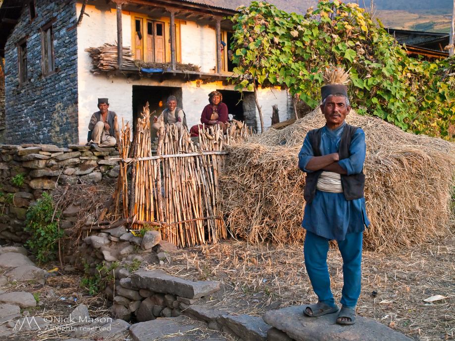 14 A Tamang farmer stands proudly in front of his home in Okhreni