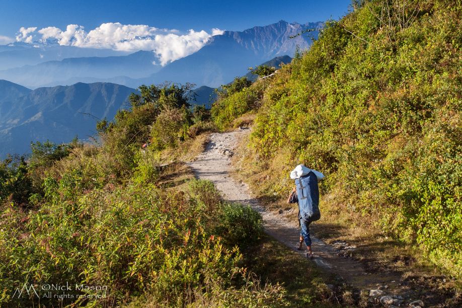 05 A porter walks through the foothills of the Himalaya near Chisapani